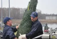 Crew Loads Christmas Trees on Historic Boat for Holiday Delivery