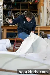 Apprentice sailmaker working on traditional sail construction