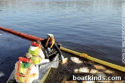 Cleanup crews collecting oiled absorbent pads after marina fire