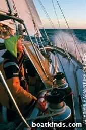 Preparing gear and reviewing charts aboard Morgan's Cloud