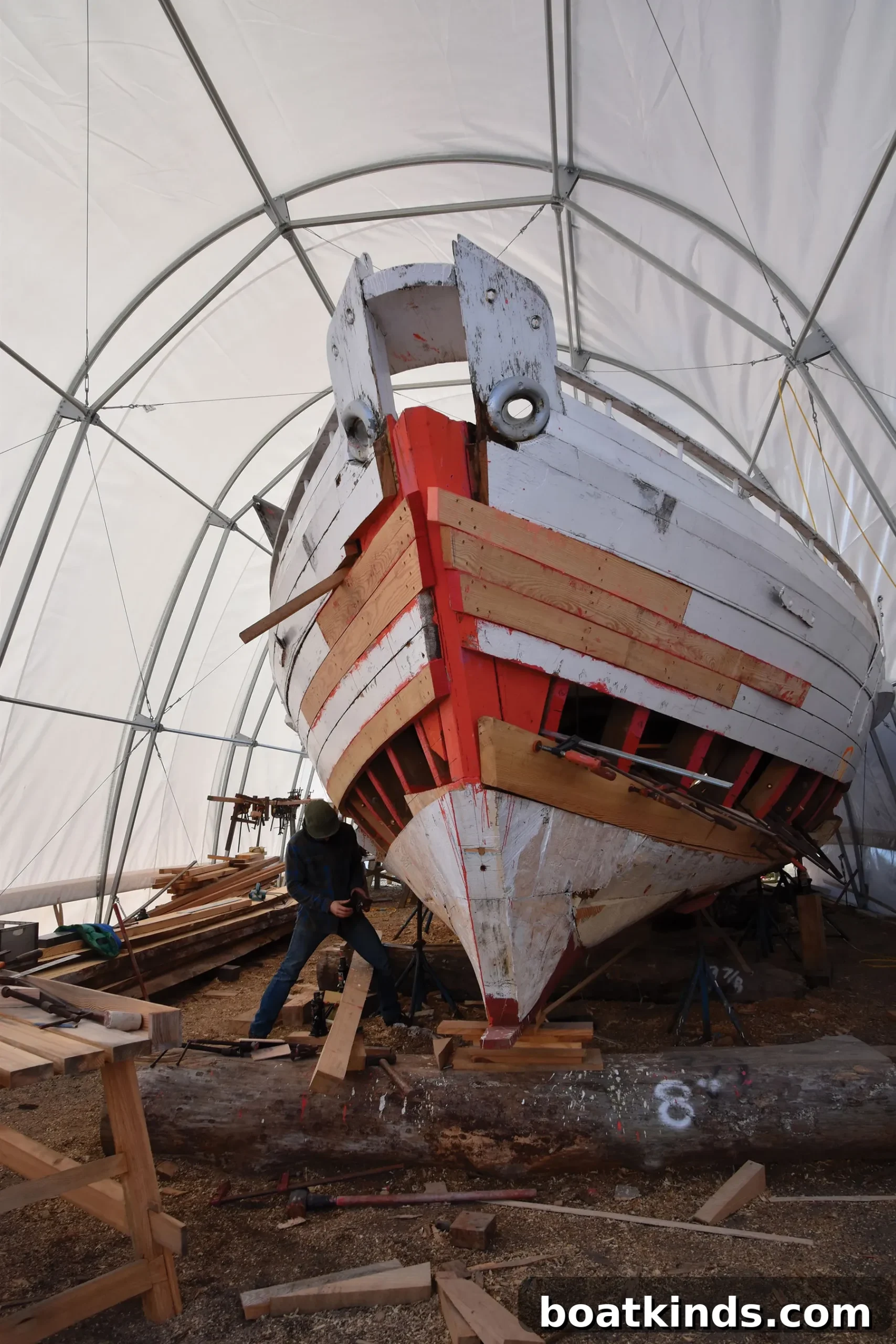 Volunteers and apprentices collaborating in the shipyard