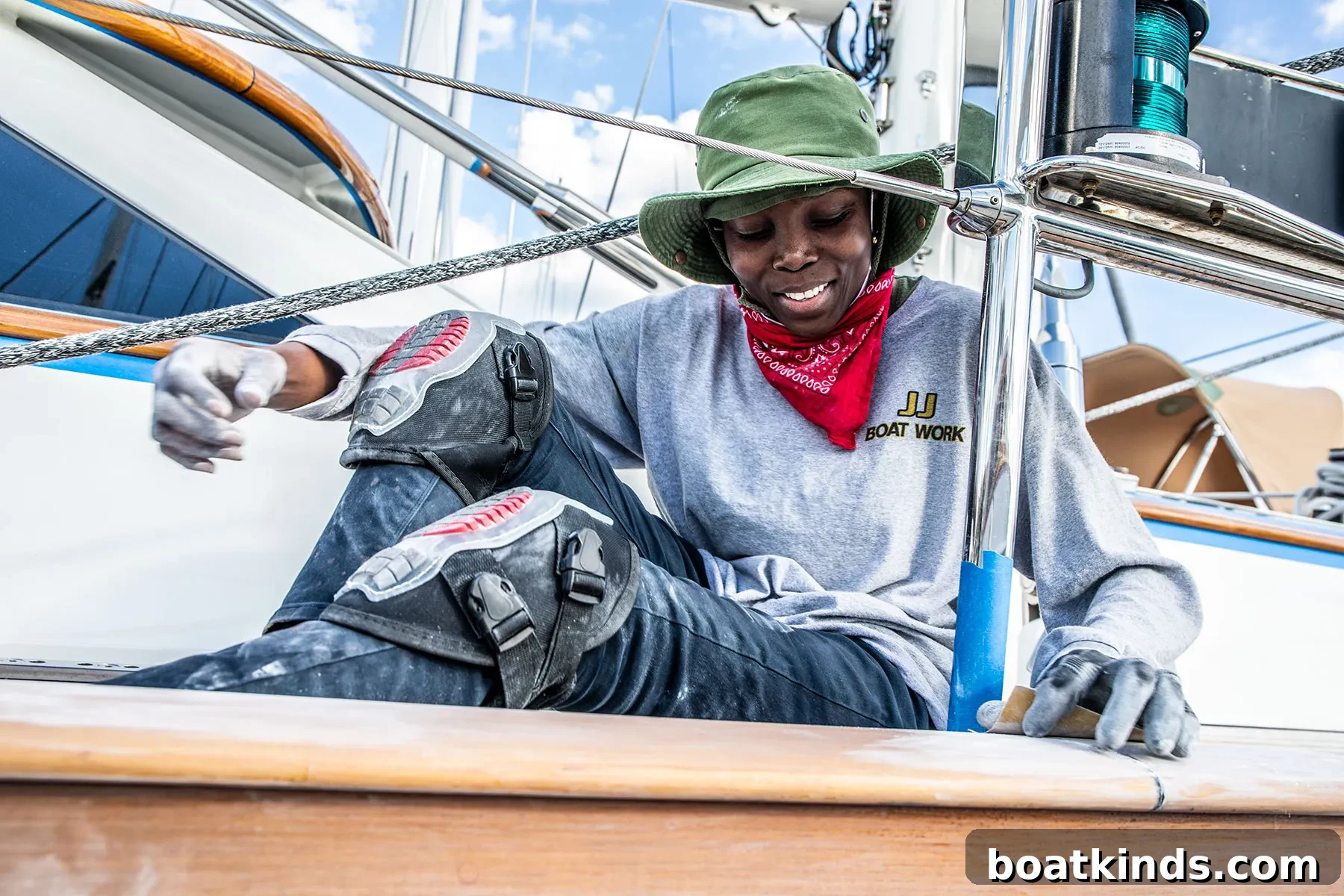 Young varnisher at work on deck