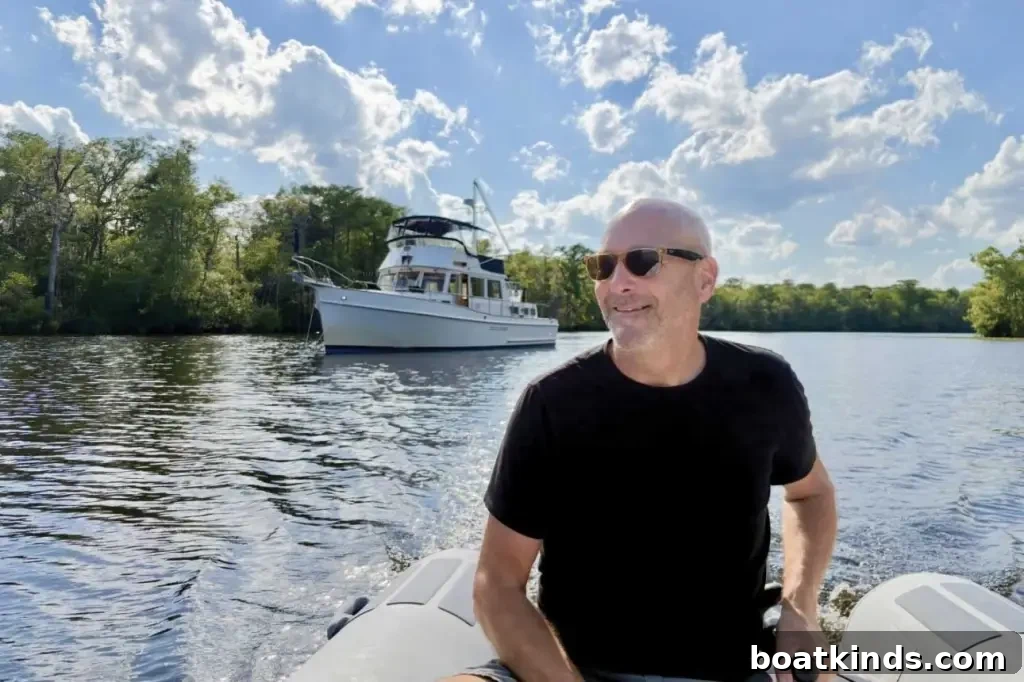 Why Owners Chose the Grand Banks 46 2 A man in a dinghy with a large boat in the background